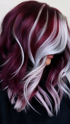 Embrace your fierce side with this fabulous hair transformation! The blend of vibrant burgundy and cool silver highlights creates a unique and eye-catching look. This hairstyle is perfect for anyone looking to express their individuality with style. #hairstyle #haircolor #haircut #wavyhair #hairinspo #burgundy Burgundy Hair Color With Blonde Highlights, Silver To Red Ombre Hair, Platinum And Burgundy Hair, Blonde And Maroon Hair Highlights, Silver Streak Hair, Silver And Teal Hair, Money Piece Ombre, Blond And Burgundy Hair, Blonde To Burgundy Hair