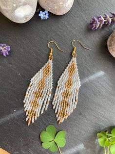 These earrings are perfect for a Hippie boho bride on her wedding day. The different textures and finishes of the white beads would be a perfect match to most wedding dresses. and if you are not getting married, fear not!! As these are also perfect summer holiday earrings to dazzle on an evening out or to stand out around the pool! These would make a perfect gift for a mum, sister, friend, girlfriend, wife.  Material: Miyuki and Czech seed beads woven using durable black thread. Technique: brick White Beaded Earrings With Gold Beads For Wedding, White Beaded Fringe Long Drop Earrings, White Long Drop Jewelry With Beaded Fringe, White Long Drop Beaded Fringe Earrings, Gold Beaded Drop Earrings For Wedding, Bohemian Gold Tassel Earrings For Wedding, Gold Bohemian Tassel Earrings For Wedding, White Teardrop Jewelry With Tiny Beads, Elegant Teardrop Earrings With Tiny Beads