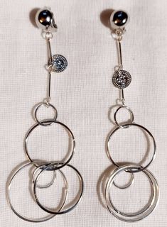 Nice light style These hang 4 inches large size Silver metal clip on Multi hoop style These are very lightweight on the ear Handmade originals Only 1 available Easy to wear Statement style They are one of a kind These Earrings are a classic and timeless addition to any wardrobe Modern Small Hoop Metal Clip-on Earrings, Trendy Clip-on Dangle Hoop Earrings, Everyday Metal Hoop Clip-on Earrings, Modern Metal Dangle Clip-on Earrings, Trendy Small Hoop Metal Clip-on Earrings, Trendy Handmade Metal Clip-on Earrings, Silver Metal Clip-on Earrings For Everyday, Everyday Hoop Clip-on Earrings, Trendy Adjustable Metal Clip-on Earrings