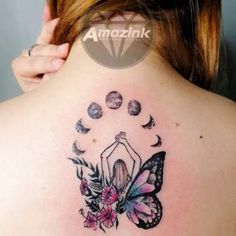 the back of a woman's neck with a butterfly and moon tattoo on it