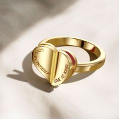 Introducing the "Chapters of Love Engraved Statement Ring," a meaningful emblem of love's profound virtues. Crafted with intention, the ring unfolds like a tenderly worn book, its heart-shaped form revealing the enduring words "Love is patient, Love is kind." Each inscription calls to mind the timeless narratives of devotion, inviting the wearer to live out these virtues.Far more than a mere adornment, this ring is a daily narrative, symbolically opening to share a message that resonates with th Symbolic Promise Jewelry For Valentine's Day, Symbolic Jewelry For Promise On Valentine's Day, Meaningful Rings For Valentine's Day Gift, Heart-shaped Promise Ring, Meaningful Valentine's Day Ring Jewelry, Valentine's Day Meaningful Ring Jewelry, Gold Engraved Heart Ring For Promise, Personalized Engraved Heart Ring For Promise, Symbolic Heart-shaped Rings For Valentine's Day