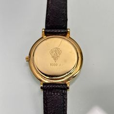 Classic ladies' Gucci watch, with minimalist black dial. Logo engraved on the crown. Quartz mechanism. New battery fitted and working perfectly.  Length: 8" Good condition overall, very light wear, no scratches on the crystal. Ships immediately Luxury Formal Watches Stamped 14k, Luxury Formal Watches 14k Stamped, Luxury 14k Stamped Formal Watches, Classic Engraved Jewelry And Watches, Classic Engraved Jewelry And Watches For Formal Occasions, Elegant Black Engraved Watch, Engraved Jewelry And Watches With Round Dial For Formal, Classic Round Engraved Jewelry And Watches, Black Engraved Watch For Formal Occasions