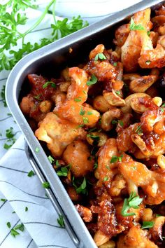 a metal pan filled with chicken wings and garnished with parsley