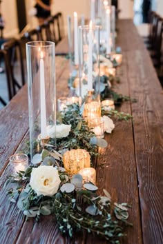 a long table with candles and flowers on it