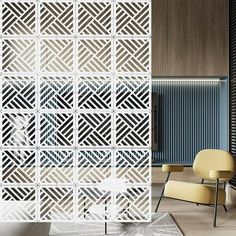 a chair sitting in front of a white wall with geometric designs on the back and sides