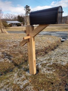 a wooden post with a mailbox attached to it