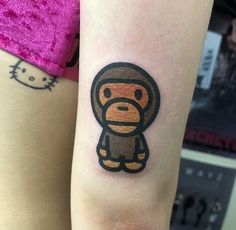 a small monkey tattoo on the left arm