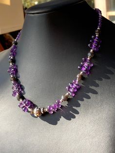 "This choker to collar length piece is graced with gorgeous Grade AAA faceted violet purple Amethyst briolette teardrop beads (approx 8mm long), and accented with faceted rondelles of rare Black Labradorite of deep black/brown with flashes of blue iridescent fire. Silver silver spacers and a decorated wire work Bali silver focal contrast beautifully with the semi precious stones for a striking look. The faceted faces of the beads reflect light in a stunning way. Silver plated hook clasp and exte Amethyst Briolette Necklace For Jewelry Making, Lavender Amethyst Teardrop Necklace, Lavender Teardrop Amethyst Necklace, Purple Briolette Natural Stone Jewelry, Purple Crystal Necklaces With Faceted Beads For Healing, Purple Faceted Beads Crystal Necklace For Spiritual Use, Purple Faceted Amethyst Crystal Necklaces, Purple Rondelle Beaded Necklace With Faceted Beads, Purple Faceted Amethyst Crystal Necklace