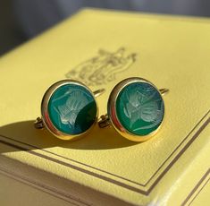 DESIGNER 18K ROMAN ARMORIAL INTAGLIO EARRINGS, SIGNED, 0.75". MIDCENTURY ITALIAN LUXURY BRAND, GENIO & BREVETTI', WERE A HIGH-END ITALIAN DESIGN COMPANY THAT WERE KNOWN FOR THEIR LUXURY ART GLASS.  THEY DID CREATE SOME JEWELRY, ALSO. CARVED GREEN CHRYSOPRASE CHALCEDONY, MOUNTED IN HEAVY SOLID 18K YELLOW GOLD. DORMEUSES/LEVERBACK SETTING. VERY WELL MADE.  WEIGHT:  4.5 grams DIMENSIONS:  0.75" x 0.5" INTAGLIOS: Carved Green Chrysoprase Chalcedony  6.05mm each HALLMARKS:  Genio & Brevetti 750 CONDITION:  some surface wear. PROVENANCE:  a Florida estate P599 Italian Luxury Brands, Floral Studs, Luxury Art, Italian Luxury, Design Company, Italian Design, Luxury Brand, Cross Pendant, Beautiful Earrings