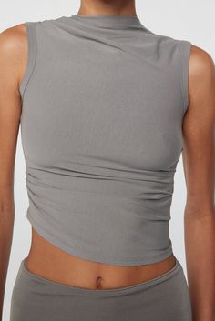 Fitted Ruched Tops For Layering, Fitted Seamless Tank Top For Everyday, Chic Fitted Seamless Tank Top, Fitted Tank Top For Everyday, Fitted Knit Tank Top For Everyday, Fitted Ruched Tank Top, Spring Modal Tank Top, Sleeveless Elastane Top With Ruched Back, Sleeveless Ruched Back Top