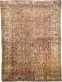 an antique rug with many different colors and patterns on the carpet, including oranges, browns