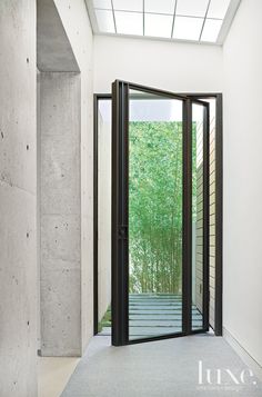 an open door leading into a room with white walls and flooring on the outside