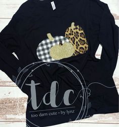 a black long sleeve shirt with leopard and pumpkin appliqued on the front