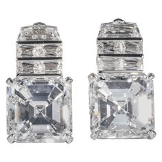 These earrings are offered by Shreve, Crump & Low. These exceptional diamond drop earrings incorporate two GIA certified asscher cut diamonds, one weighing 9.19 carats with a color and clarity of F VVS1 (GIA report no. 5191337302), the other weighs 9.02 carats with a color and clarity of G VS1 (GIA report no. 1192389989). The asscher cut diamonds are set with 2 step cut trapeziods, and 8 baguette cut diamonds (4 per earrings) weighing a total of 3.32 carats with a color and clarity of F-G VS1-VS Three Stone Engagement Rings Emerald, Emerald Cut Diamond Earrings, Princess Cut Earrings, Large Gold Earrings, Gold Diamond Drop Earrings, Rings Emerald, Oval Cut Diamond Rings, Cushion Cut Diamond Ring, Emerald Cut Diamond Ring