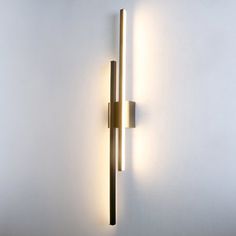 a wall mounted light with two lights on it's side and one is lit up