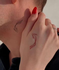 a man and woman with matching tattoos on their neck, both looking at each other