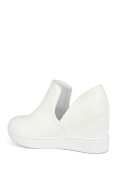 Add some freshness to your wardrobe with the Cardi sneaker by Journee Collection. This easy slip-on style shoe features a hidden wedge design with a round toe and platform bottom. The deep V side cut-outs add a unique touch and create an easy entry. Sizing: True to size. M=medium width. Round toe. Slip-on style. Split sides. Approx. 3" heel height. Approx. 3.5" shaft height, 11" opening circumference. ImportedThis item cannot be shipped to Canada.