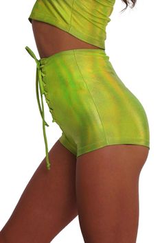 Own the Limelight in our Neon Green Lace Up Shorts. These womens holographic highlighter chartreuse high waist shorts are fantastically fluorescent and UV reactive! Pair them with the Square Neck Crop Top for a matching two piece set. FEATURES: Made with high quality 4 way stretch holographic spandex that feels thick and luxy and holds its shape High waisted UV reactive, glows in blacklight Adjustable laces in front, but stretchy enough to pull on and off without adjusting them Booty shorts leng Neon Bottoms For Summer Party, High Waist Rave Bottoms For Spring, Neon Yellow Shorts For Summer, Fitted Neon Summer Bottoms, Fitted Neon Bottoms For Summer, Fitted Green Bottoms For Rave, Neon Yellow Stretch Bottoms For Summer, Stretch Neon Yellow Bottoms For Summer, Summer Rave Style Shorts