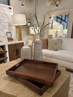 a living room filled with lots of furniture and decor on top of a wooden table