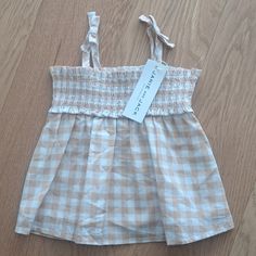 The Leilani Gingham Smocked Top Cute Cotton Smocked Top For Summer, Spring Gingham Smocked Top With Smocked Bodice, Cute Cotton Smocked Top For Spring, Summer Smocked Top For Picnics, Summer Cotton Plaid Smocked Top, Summer Plaid Cotton Smocked Top, Summer Smocked Top For Picnic With Smocked Back, Spring Gingham Top With Smocked Bodice, Summer Gingham Top With Smocked Back