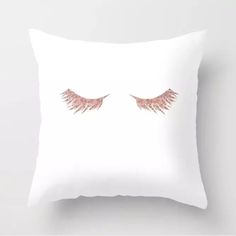 a white pillow with pink wings on it