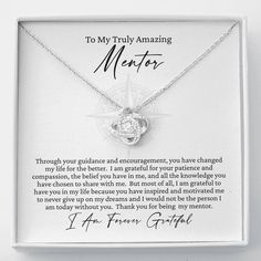 a necklace in a white box with an inscription on the front saying to my truly amazing mentor