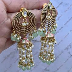 A Premium quality fusion meenakari pearl tassels chain earrings with the silver foiled kundan. Light Weight Earrings length: Approx. 3.5” Push - back closure Antique Gold plated on high-quality brass as base metal Availability: In-Stock *Color may vary slightly due to light condition & photography. Jewelry Care: Keep away from moisture. Allow perfumes and lotion to dry before wearing. Store in jewelry pouch. Clean only with soft lint free cloth. Festive Fusion Chandelier Earrings With Latkans, Festive Fusion Style Dangle Danglers, Festive Fusion Dangle Danglers, Diwali Fusion Style Dangle Danglers, Metal Fusion Style Chandbalis For Festivals, Fusion Style Danglers For Diwali, Fusion Kundan Chandelier Earrings With Latkans, Fusion Style Kundan Chandelier Earrings With Latkans, Kundan Fusion Dangle Jhumkas