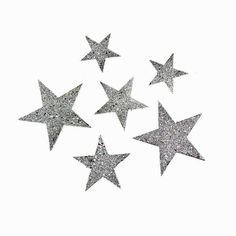 six silver glitter stars on white background