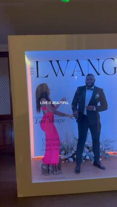 a man and woman standing in front of a window display with the words love is beautiful