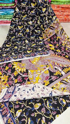 ## Exquisite Cotton Kalamkari Sarees ### Timeless Elegance and Traditional Craftsmanship Immerse yourself in the rich heritage and timeless elegance of our Cotton Kalamkari Sarees. These sarees beautifully showcase the intricate Kalamkari craft, combining traditional artistry with the natural comfort of pure cotton. ### What is Kalamkari Craft? Kalamkari is an ancient Indian art form that originated in the regions of Andhra Pradesh and Telangana. The term "Kalamkari" is derived from the Persian words "Kalam" (pen) and "Kari" (craftsmanship), reflecting the intricate hand-painted or block-printed designs created with a pen or wooden blocks. This labor-intensive process involves natural dyes and elaborate detailing, resulting in exquisite patterns and vibrant colors. ### Unique Features - ** Multicolor Anarkali Style Pre-draped Saree With Printed Motifs, Anarkali Style Multicolor Pre-draped Saree With Printed Motifs, Traditional Pre-draped Saree With Printed Motifs For Diwali, Festival Unstitched Suit With Printed Motifs In Traditional Drape, Festival Unstitched Suit With Traditional Drape And Printed Motifs, Festive Unstitched Suit With Traditional Drape, Festival Unstitched Suit With Printed Motifs, Festive Unstitched Suit With Traditional Drape And Printed Motifs, Traditional Yellow Kalamkari Print Sets