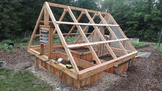 a wooden structure with plants growing in it