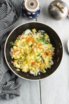 a bowl filled with chopped vegetables on top of a table