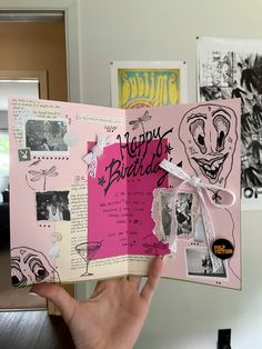 someone holding up a pink birthday card with pictures and writing on the inside of it