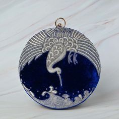 Royal blue clutch bag made on velvet fabric enhance the beauty of this round clutch for all occasions and attires. The handcrafted American swan bag with intricate zardozi work makes a opulent factor for all occasions. The metal string makes it long lasting and has enough room to carry essentials and more.. This beautifully embroidered Round Clutch Bag is hand crafted using zardozi technique. Zardozi work is done carefully stitching layer upon layer of threads and metal wires and embellished with precious or semi precious gemstones making each piece one of its kind. Size cm : 18X18X06 Utility : Shoulder Bag / Clutch Bag Material: Velvet Fabric, Metal Thread Stones : No Stone Base Color Available : Blue Care : Dry clean only Please Note - This product has been crafted by hand and may have s Royal Blue Clutch, Swan Bag, Blue Clutch Bag, Zardosi Work, Zardozi Work, Blue Clutch, Handcrafted Bags, Beautiful Handbags, Embroidered Bag