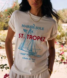 Set sail in style with our "St. Tropez Sailing Club" T-Shirt, inspired by the chic and elegant vibes of the French Riviera. This vintage nautical design features a stylized logo of the renowned St. Tropez Sailing Club, capturing the charm and sophistication of this exclusive destination. Crafted from premium, soft cotton, this tee ensures exceptional comfort while showcasing a timeless and fashionable look. Ideal for sea lovers, yachting enthusiasts, and anyone who adores the Tropezian lifestyle, this T-shirt is a must-have for your summer wardrobe. Wear it to add a touch of coastal elegance to any outfit! Details: Material: 100% Cotton Sizes: XS, S, M, L, XL, XXL Colors; White, Natural, Soft Pink Care: Machine wash cold, tumble dry low Designed with love and crafted for comfort ❤️ Pair it French Riviera Design, Nautical Short Sleeve Beach Top, White Nautical Crew Neck Top, White Nautical Tops For Vacation, Nautical Style Cotton Tops For Vacation, Nautical Cotton Tops For Vacation, Cotton Nautical Tops For Vacation, Nautical Graphic Print T-shirt For Sailing, Nautical Style Summer T-shirt With Letter Print