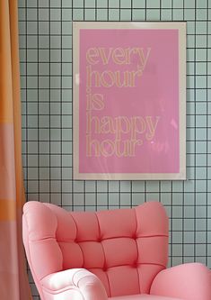 a pink chair sitting in front of a wall with a poster above it that says every hour is happy hour