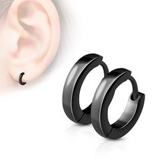 two pairs of black hoop earrings are shown next to an earring that is attached to the