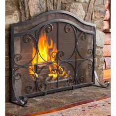 a fire place in the middle of a room with stone walls and wood flooring