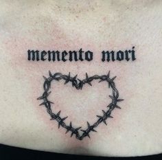 a woman's chest with barbed wire and the words, mementoo mort on it