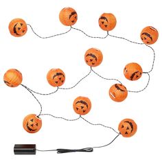 a string of pumpkin lanterns with faces drawn on them