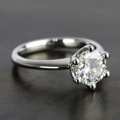 a diamond ring on a wooden table