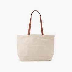 Heritage Tote-all Bag - White | Levi's® US Practical Canvas Bag With Double Handle, Cream Canvas Bag With Adjustable Strap, Canvas Bucket Shoulder Bag With Leather Handles, Canvas Tote Satchel With Pockets, Canvas Shoulder Weekender Bag With Pockets, Everyday Beige Shoulder Bag With Canvas Lining, Canvas Bags With Leather Handles And Double Handle, Beige Shoulder Bag With Canvas Lining For Everyday, Beige Canvas Shoulder Bag For Everyday