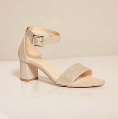 a women's sandal with two straps on the front and one heel in gold glitter