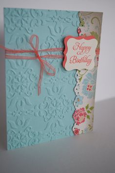 a blue birthday card with a pink ribbon on the front and white background that says happy birthday