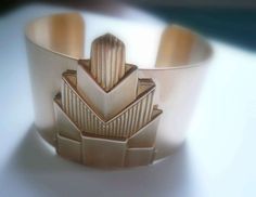 A wide brass Gatsby era style bracelet cuff with a geometric, nearly atomic art deco design.

 	This is a handmade cuff made from new findings.
 	Cuff is 6" (15cm) from end to end and 1 1/2" wide.
 	Yes! Custom sizing is available. Cuff can be made smaller or larger while shaping. Contact us to make a custom request.

Visit the minusOne Chrysler Collection for more Art Deco finds. Atomic Art, Great Gatsby Style, Big Bracelets, Great Gatsby Fashion, Large Bracelet, Art Deco Bracelet, Gatsby Style, Chrysler Building, Brass Bracelet