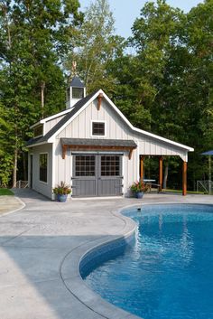 a small pool house next to a swimming pool