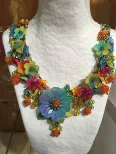 Dripping with colorful hand-painted flowers and glass beads, what a perfect necklace to make you feel like your on a holiday in Havana. This necklace has multi colored flowers of turquoise, yellow, orange and red. A unique and bright fun color combo. It measures almost 20 inches with a 4 inch extender so as you may adjust the length as needed. We use findings that are nickel free. This is a hand beaded piece of jewelry. All the work is hand sewn or wired without the use of glue. This heirloom qu Vibrant Rainbow Jewelry With Colorful Design, Whimsical Multicolor Beaded Necklace For Festival, Whimsical Multicolor Beaded Necklaces For Festivals, Orange Bohemian Flower Necklace, Multicolor Flower Shaped Beaded Necklace For Festivals, Multicolor Flower Necklace With Colorful Beads For Festivals, Yellow Flower Necklace With Colorful Beads, Bohemian Multicolor Flower Necklace With Colorful Beads, Multicolor Flower Necklace With Flower Decoration