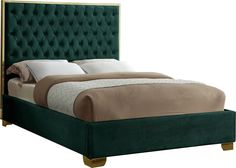 a bed with a green velvet headboard and foot board