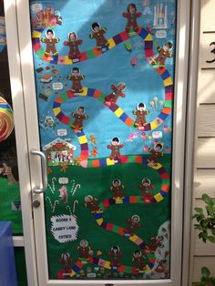 a door decorated with paper cut outs and stickers on the front, along with an image of children's characters