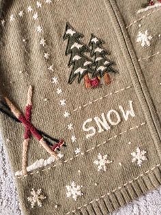 an ugly sweater with the word snow written on it